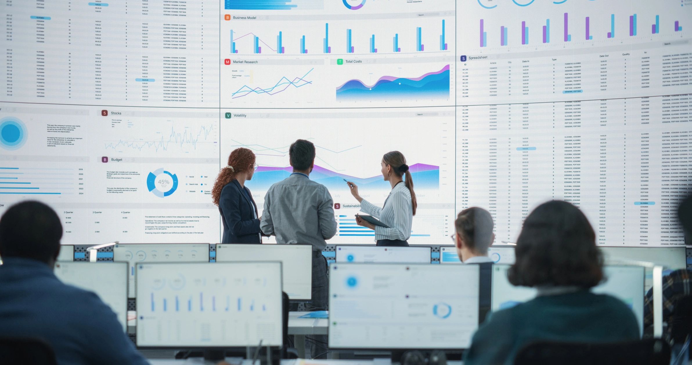 Team reviewing analytics dashboards in a modern technology operations center